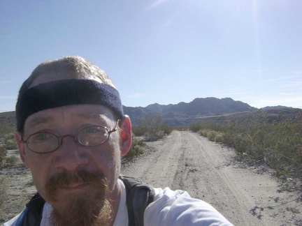 My miles of walking the bike through kitty litter come to an end when Jackass Canyon Road rises out of the wash