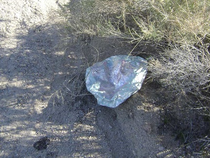 A happy-Mother's-Day balloon rests deflated near the road