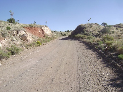 Ivanpah Road passes through a slot in the earth near the summit