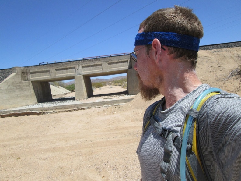 2.5 miles beyond Nipton, I'm feeling hot again and notice some potential shade as I cross under the power lines