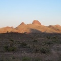 The nearby Castle Mountains and Hart Peak radiate in the sunset near Malpais Spring