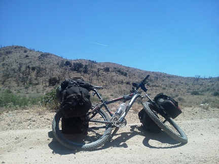 A jet flies overhead while I ride Cedar Canyon Road; the passengers note in unison that 'there's nothing down there'