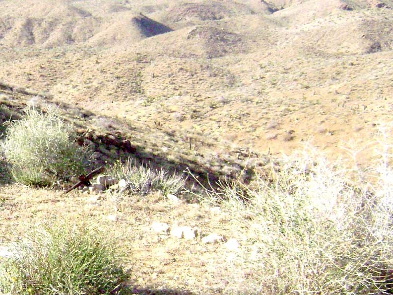 Not far from the outhouse at Tough Nut Mine rest some rocks and a tiny wooden cross to mark a grave site