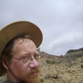 The Mojave storm clouds have brought high winds that try to blow the hat off my head