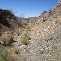 As I continue hiking along the abandoned Ivanpah railway grade, I notice that the road deteriorates