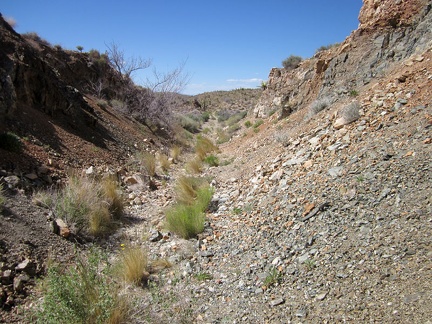 As I continue hiking along the abandoned Ivanpah railway grade, I notice that the road deteriorates