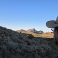 I can't see my nearby campsite yet while hiking down this hill, but I do get a good glimpse of the Castle Peaks along the way