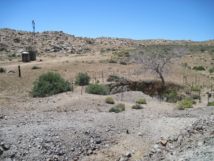 I stand on a small tailings pile at Gold Valley Mine and look down at an old pit