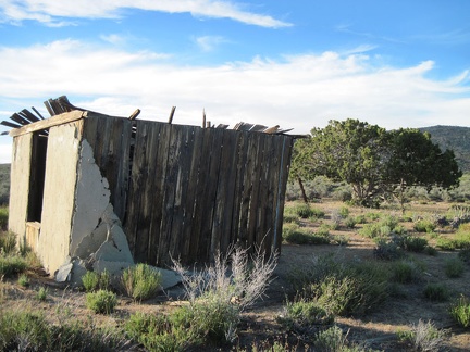 The stucco exterior on the south exterior wall of the Gold Valley cabin is peeling off