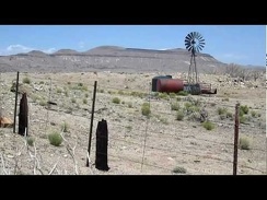 I ride past a windmill in Round Valley on Black Canyon Road