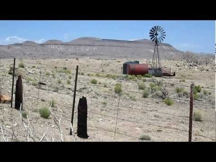 I ride past a windmill in Round Valley on Black Canyon Road