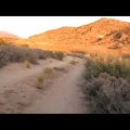 I ride along Woods Wash Road around sunset toward an as-yet-unknown campsite