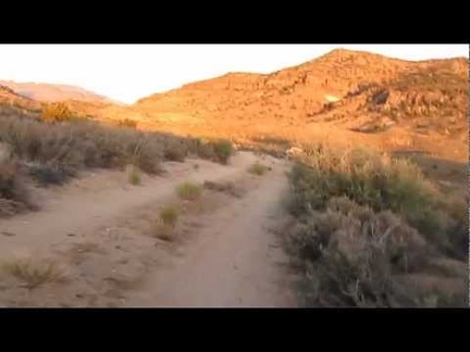 I ride along Woods Wash Road around sunset toward an as-yet-unknown campsite