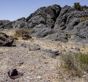 Rusted tin can and rock outcrop