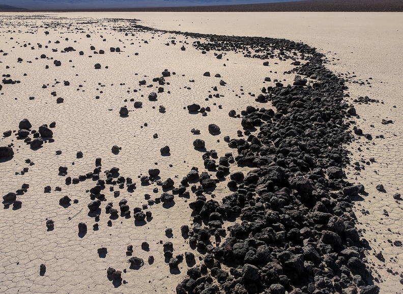 Wind blows rocks to the other side of the dry lake