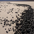 Wind blows rocks to the other side of the dry lake