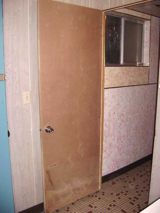 The particle-board door on the bathroom has never been painted