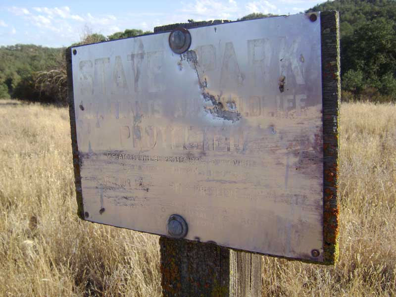 An old State Park boundary sign across the Paradise Flat meadow.