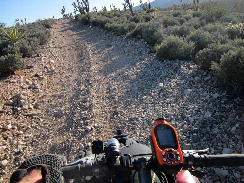Loose rock and an uphill grade require that I walk the 10-ton bike up parts of the road toward the Pine Spring area